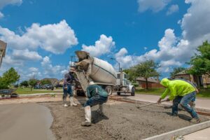 Concrete contractors finishing a freshly resurfaced driveway in Green Cove Springs FL